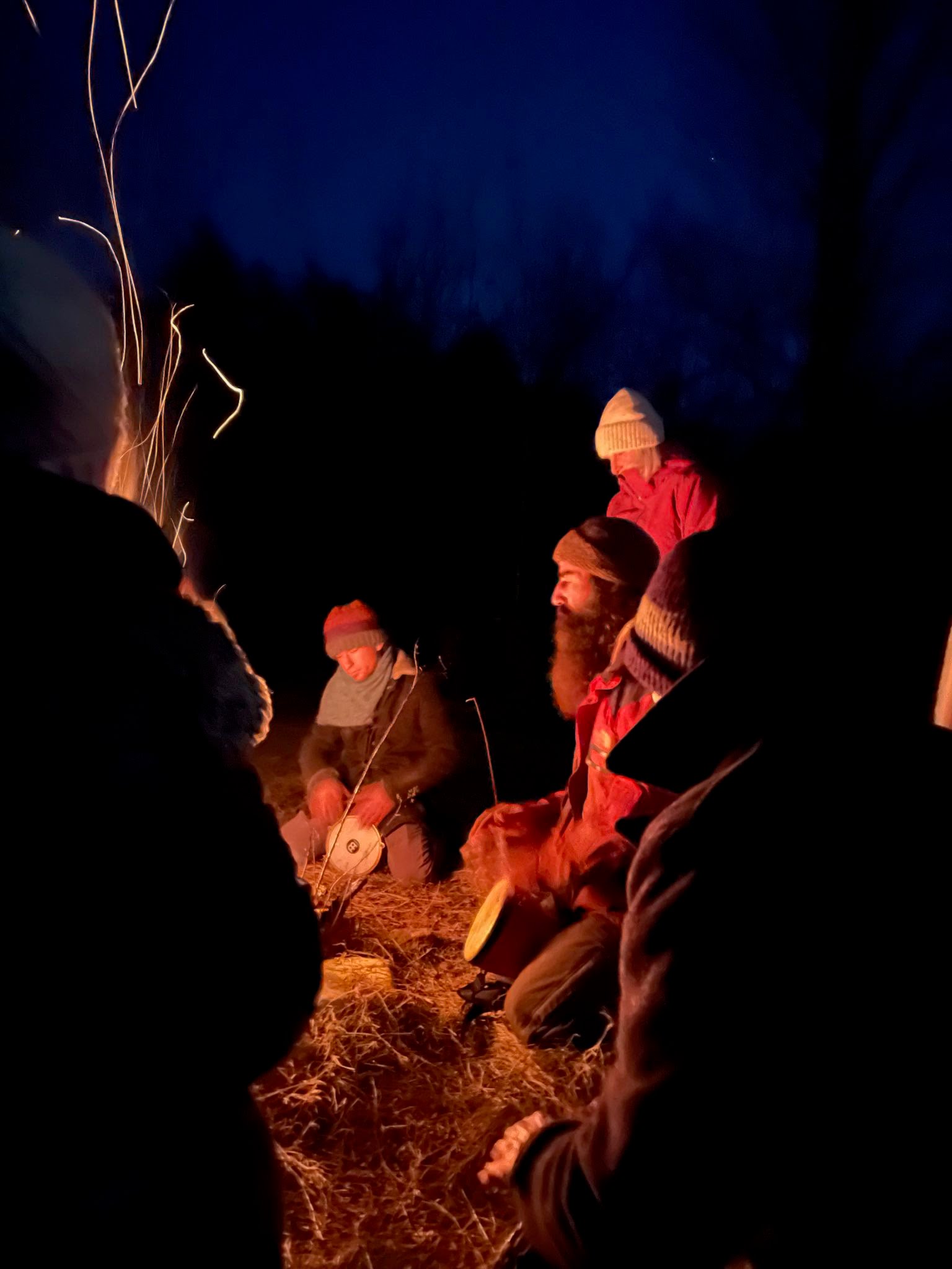 Drumming to the fire and the moon.